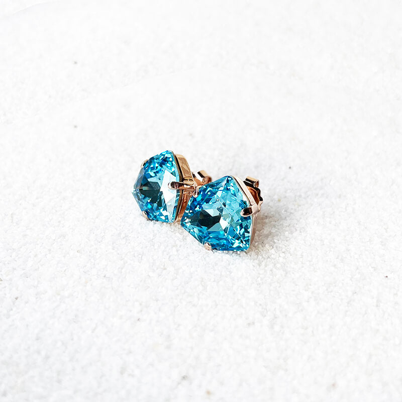 Aquamarine stud earrings with a blue Swarovski set in rose gold side view