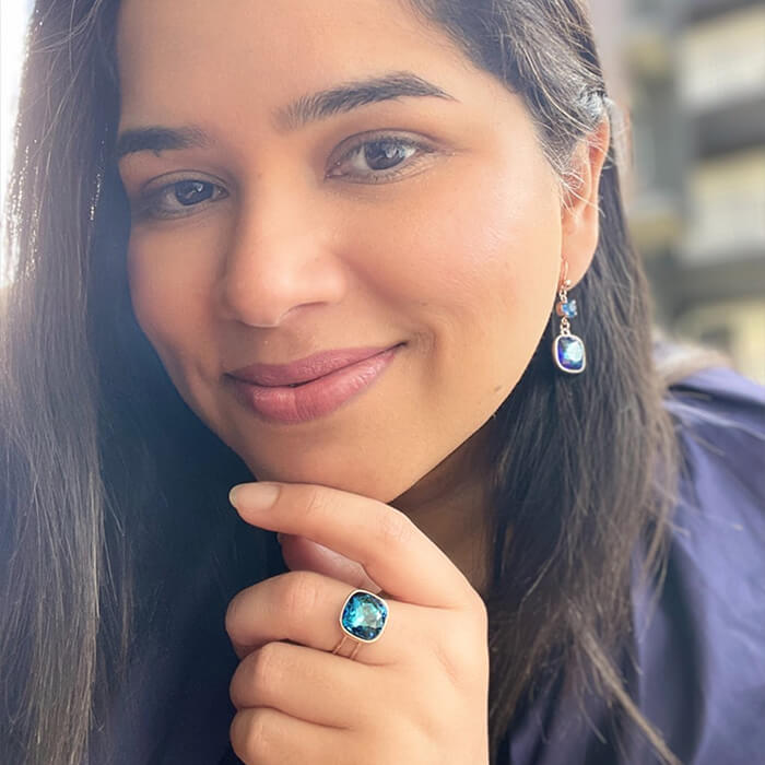 Swarovski dangle earrings and ring on model