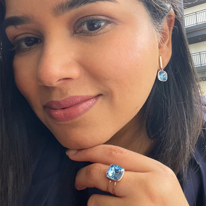 Blue Swarovski drop earrings on model