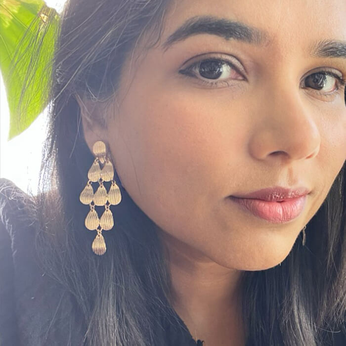 rose gold dangle earrings on model