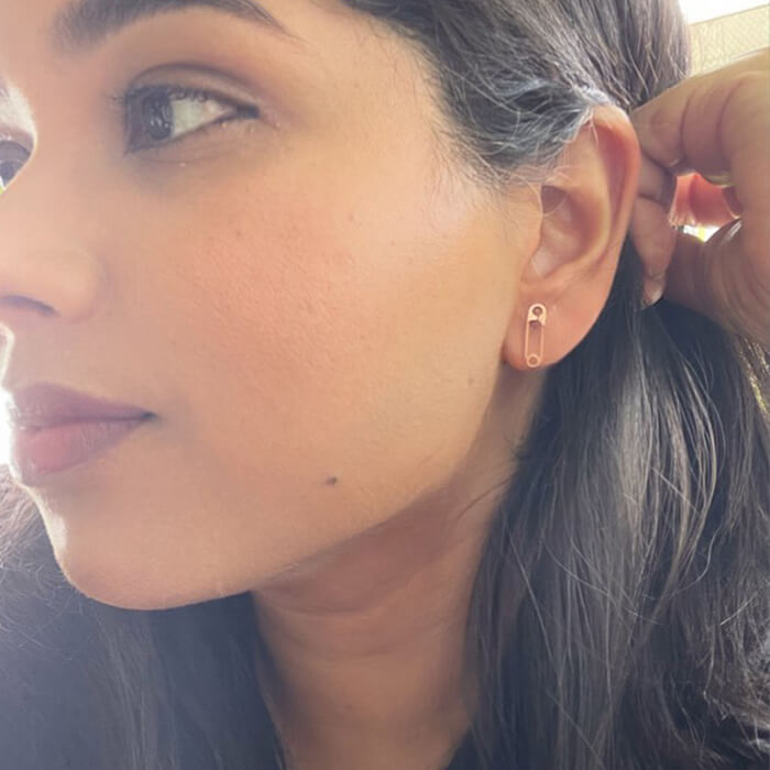 safety pin earrings rose gold on model