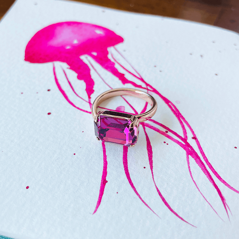 Swarovski pink ring, adjustable ring. against pink backgrounf