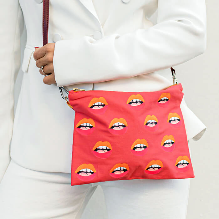 pink hand painted bag with lots of lips as crossbody