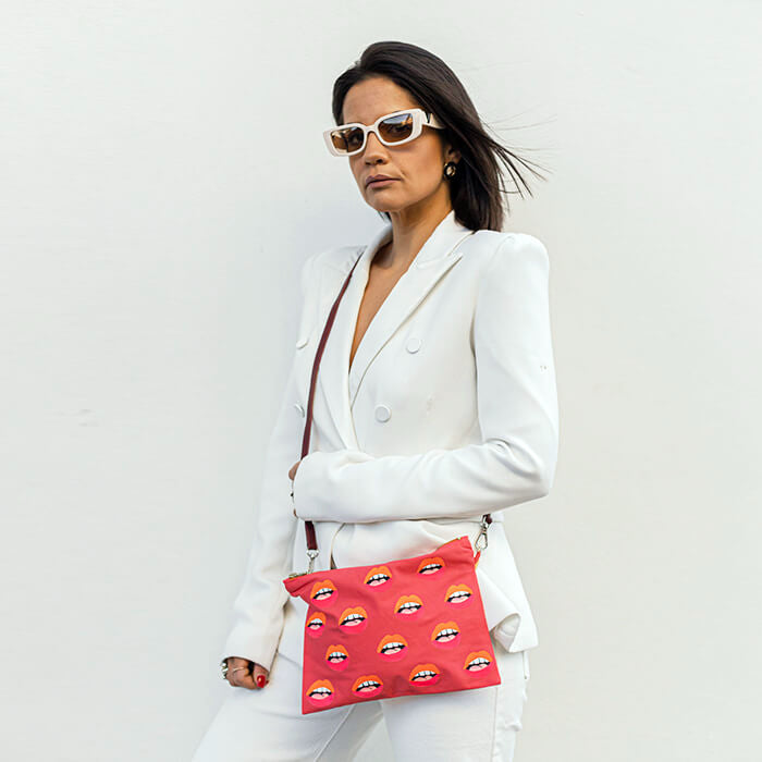 pink hand painted bag with lots of lips on model