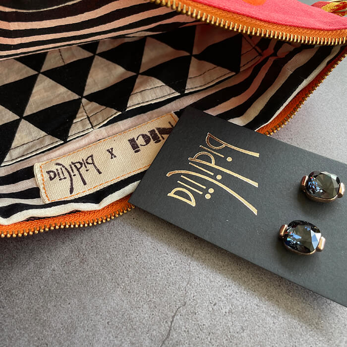 pink hand painted bag with lots of lips details 