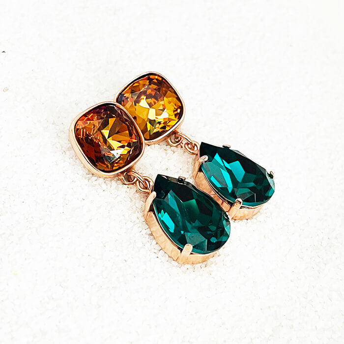 Swarovski Emerald Earrings with pear shaped emerald Swarovski and Light Amber Swarovski flat lay view