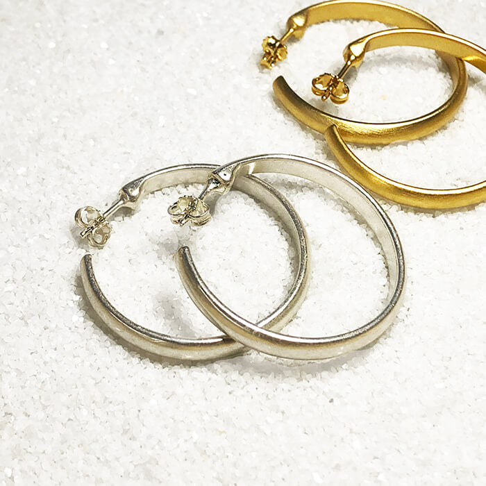 brushed silver hoops and thick gold hoops