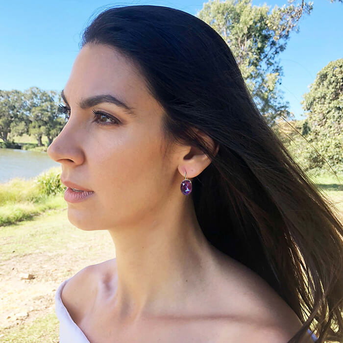 rhodium finish and burgundy purple unique crystal drop earrings on model