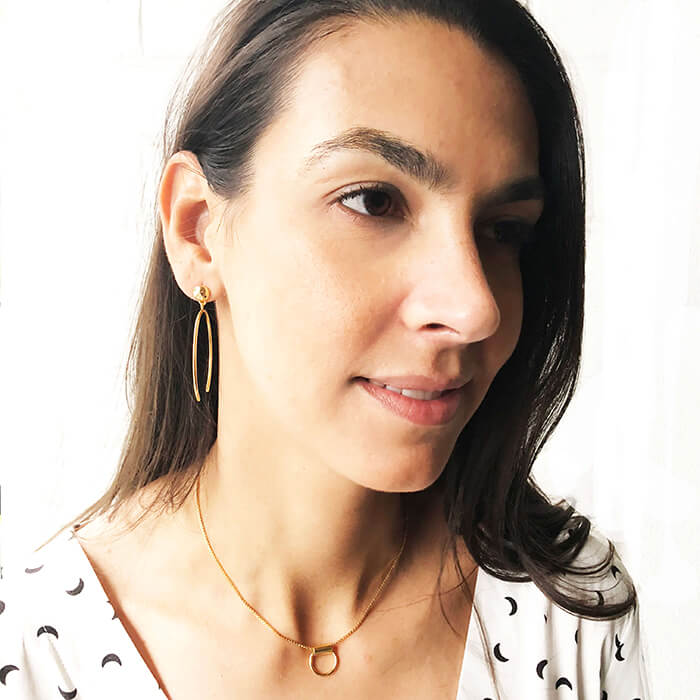 elegant ethical earrings and minimalist pendant on model