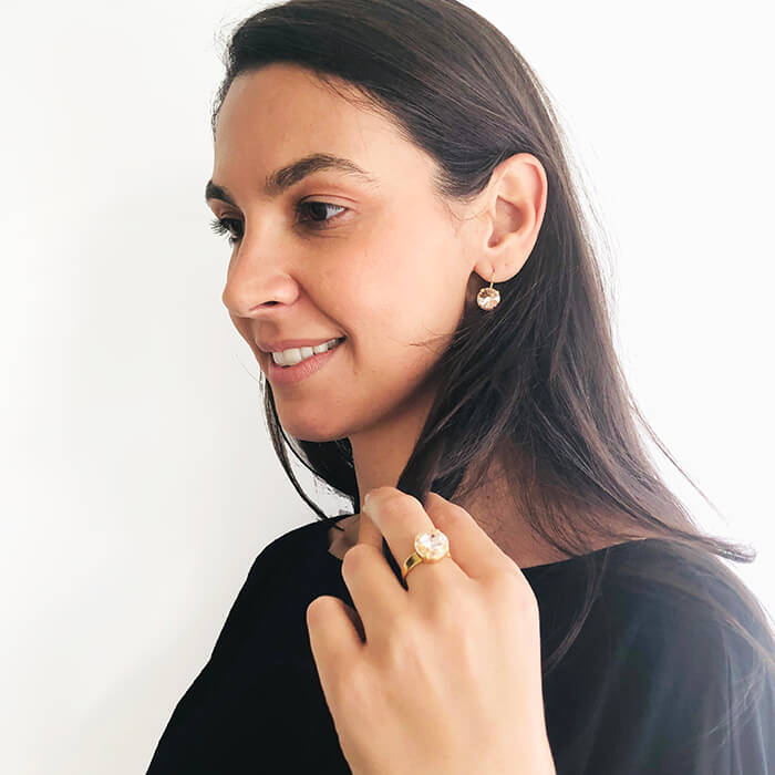 Swarovski gold earrings and ring on model