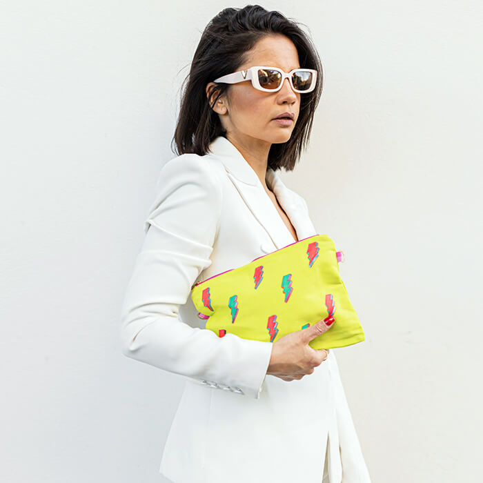 Neon Clutch bag with hand painted fluoro lightening bolts on model