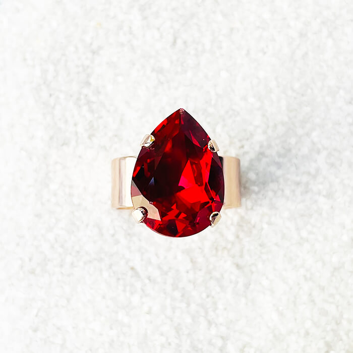 Red ring with a red pear swarovski set in rose gold top view 