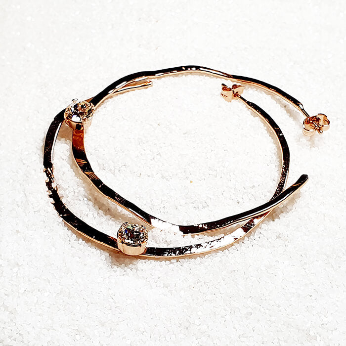 large rose gold hoop earrings with swarovski, flatlay image