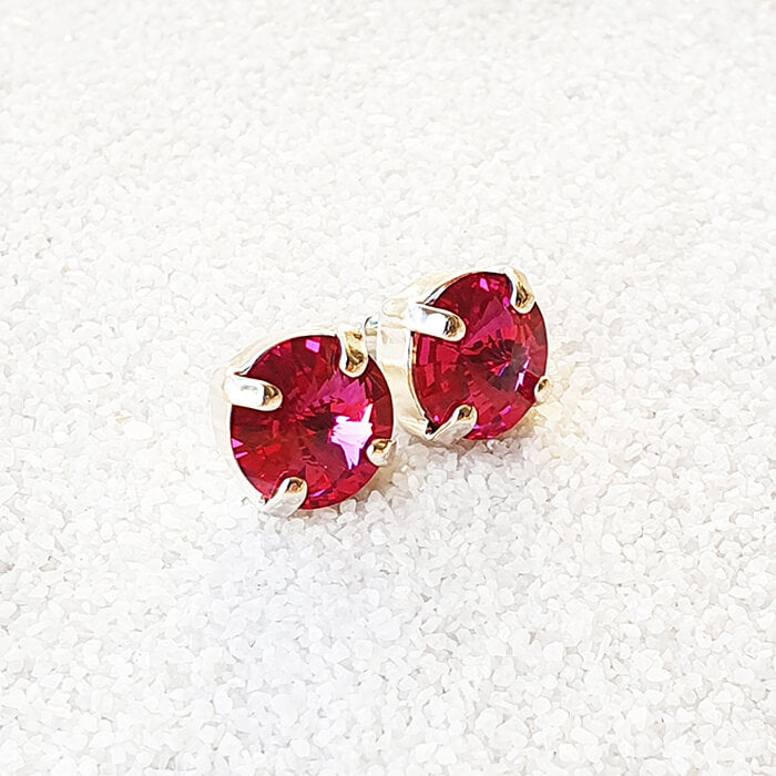 swarovksi stud earrings in silver with bright pink swarovski crystal close up 