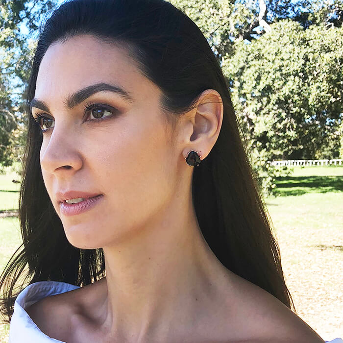 versatile stud earrings with black resin on model